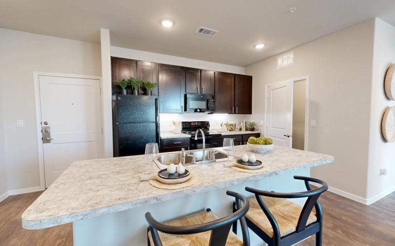 a kitchen with an island and chairs