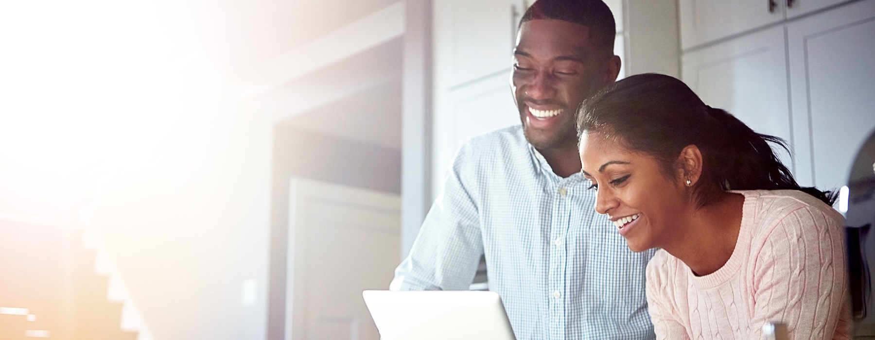a man and a woman looking at a tablet