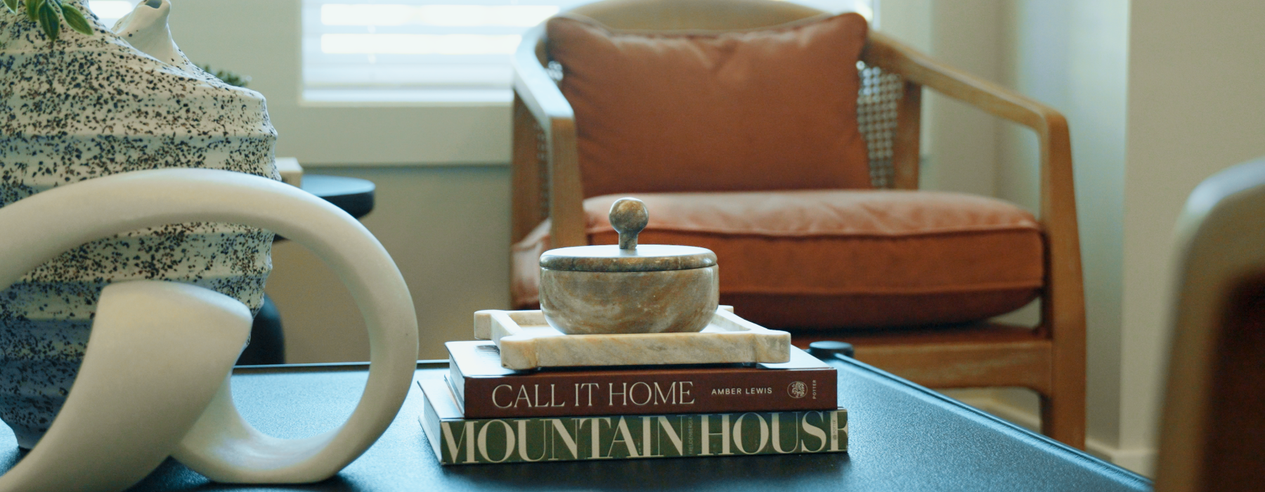 Leasing office seating - one chair with coffee table and decorative books