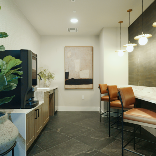 Coffee lounge seating with barstool seating on one wall and the coffee machine on the opposite wall