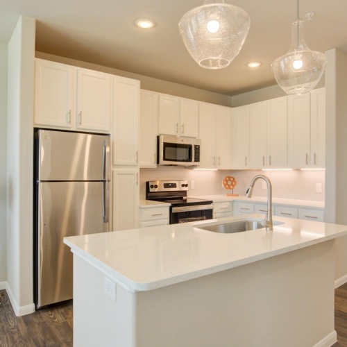 a kitchen with white cabinets